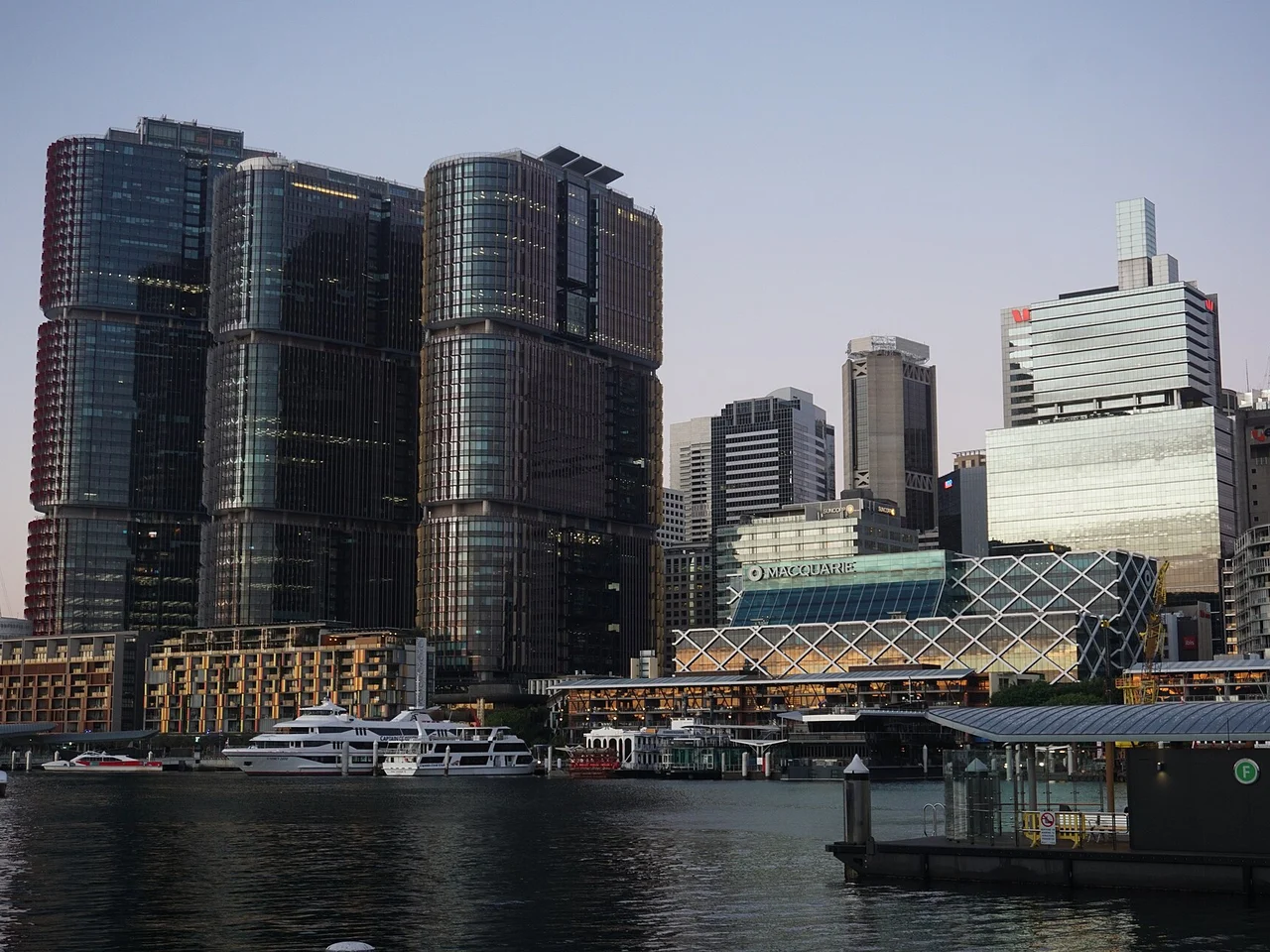 The Barangaroo waterfront precinct and International Towers on Sydney Harbour at dusk.